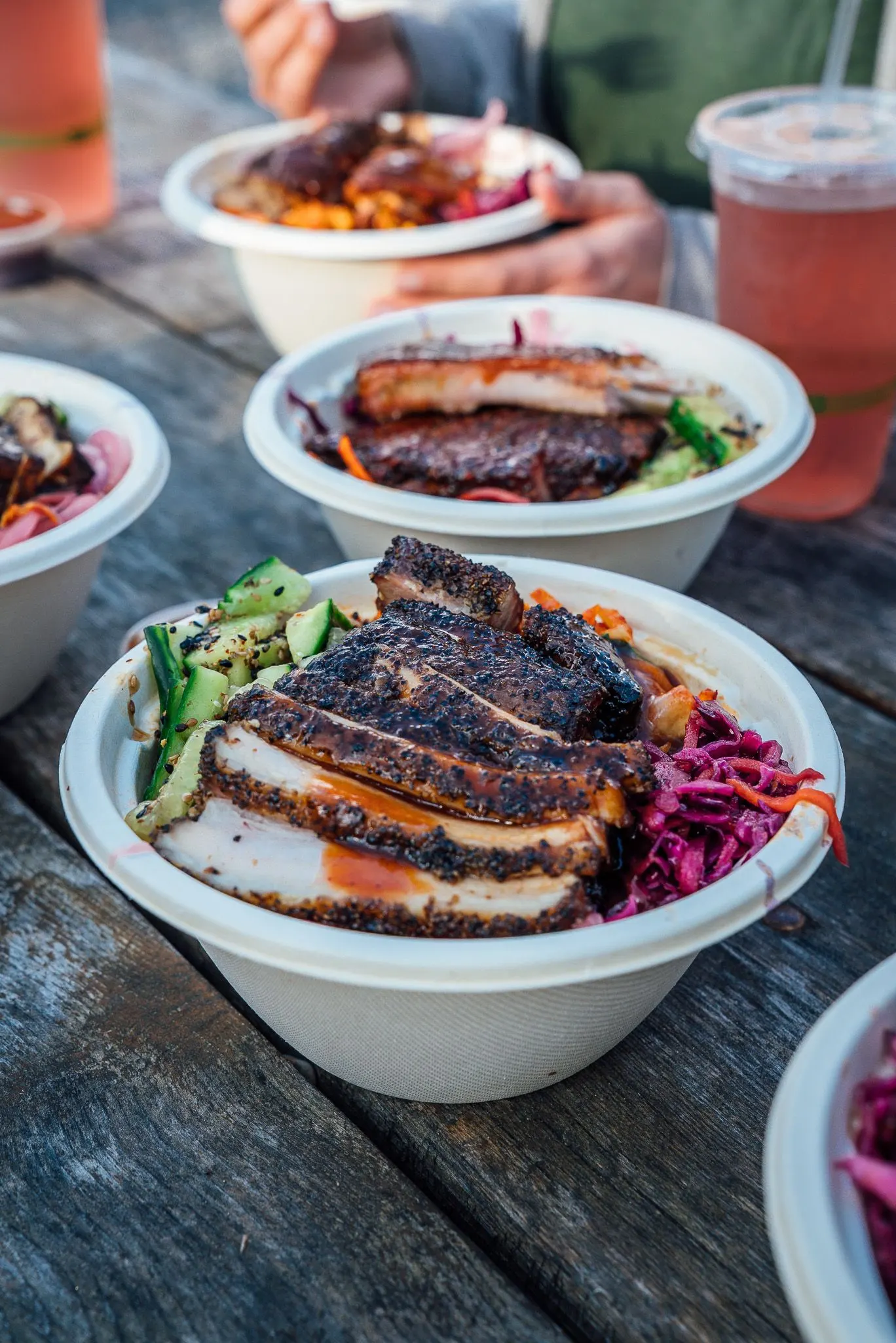 A rice bowl sits on a picnic table