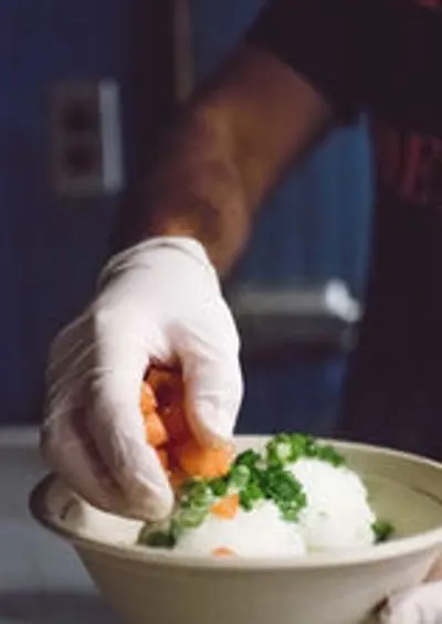 Adding vegetables to a rice bowl