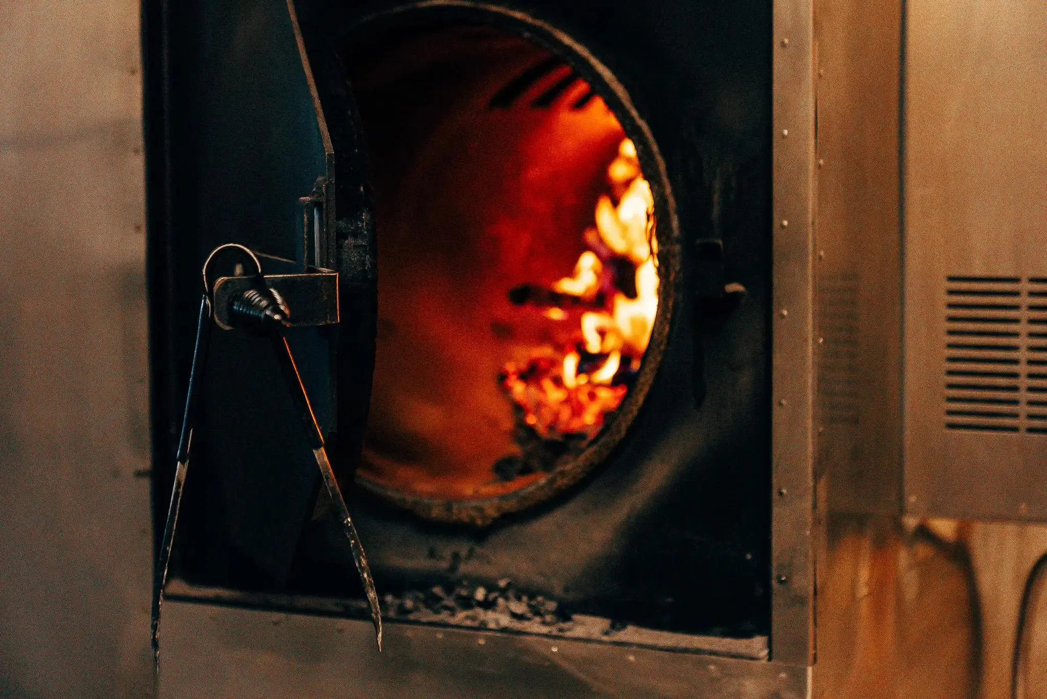 An open barbeque with logs burning inside.