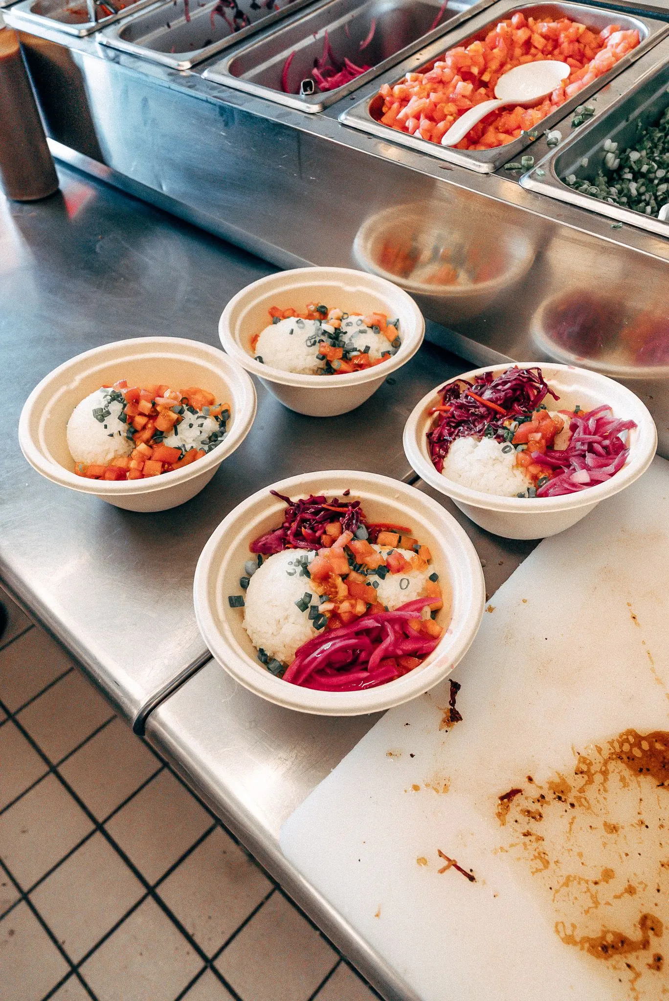 four rice bowls sit in a preparation area