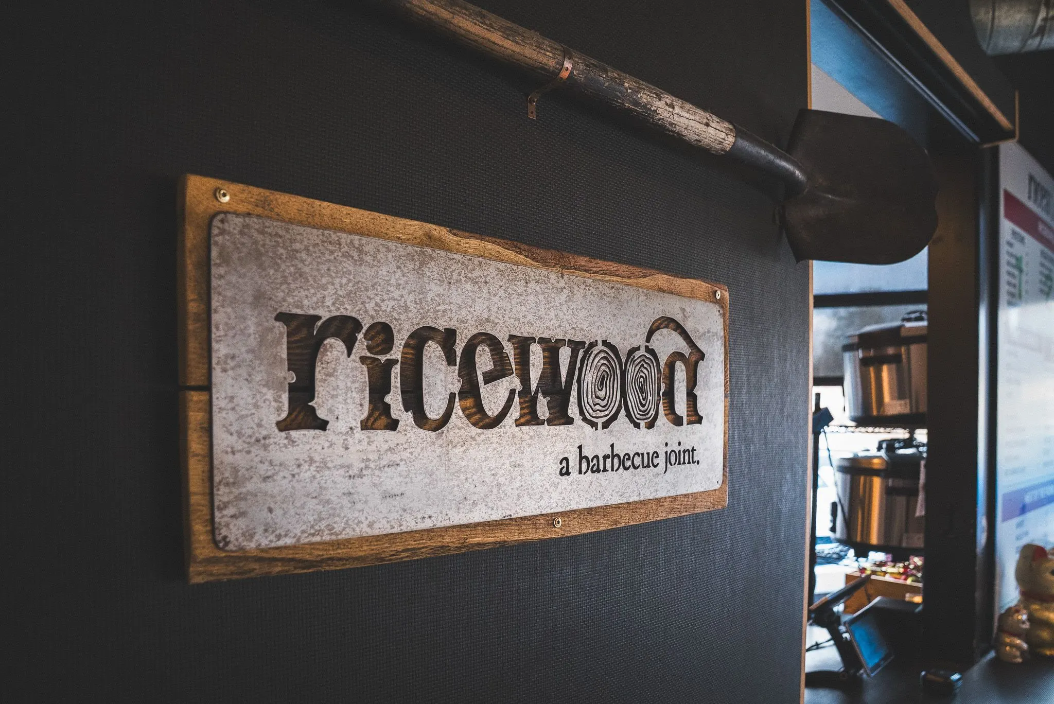The "ricewood" sign on the wall next to the ordering counter