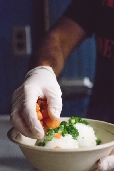 Adding vegetables to a rice bowl