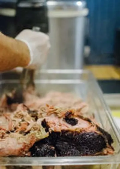 Grabbing brisket with tongs
